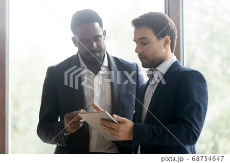 Caucasian manager offer a deal to african client 68734647