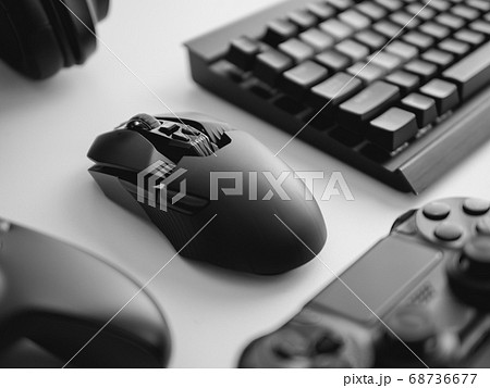 gamer work space with gaming gear, mouse, keyboard, joystick, headset on white table background. gamer work space with gaming gear, mouse, keyboard, joystick, headset on white table background. 68736677