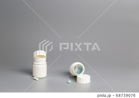 White plastic bottles of medicine and pills White plastic bottles of medicine and pills 68739076