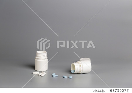 White plastic bottles of medicine and pills White plastic bottles of medicine and pills 68739077
