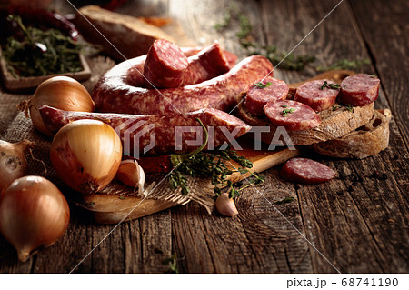 Dry-cured sausage with bread and spices on a old Dry-cured sausage with bread and spices on a old 68741190