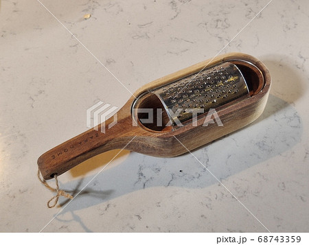 grater for vegetables is on the table in white 68743359