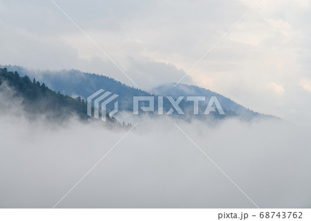 Majestic view on beautiful fog and cloud mountains Majestic view on beautiful fog and cloud mountains 68743762