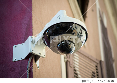 Closeup of security camera on stoned wall Closeup of security camera on stoned wall 68743836