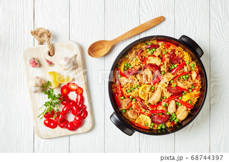 spanish chicken paella in a black dish spanish chicken paella in a black dish 68744397