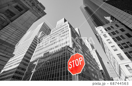 Red stop sign with black and white buildings, New York. Red stop sign with black and white buildings, New York. 68744563