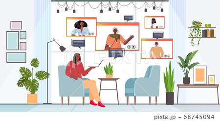 woman having virtual meeting with family members during video call online communication concept woman having virtual meeting with family members during video call online communication concept 68745094