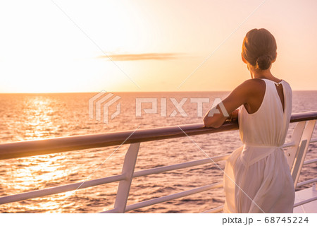 Cruise ship luxury travel holiday destination woman on Europe summer vacation. Elegant lady relaxing on outdoor deck looking at view of Mediterranean Sea. 68745224