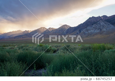 Mountain range with clouded colorful sunset, Eastern Sierra Nevada Mountains Mountain range with clouded colorful sunset, Eastern Sierra Nevada Mountains 68745257