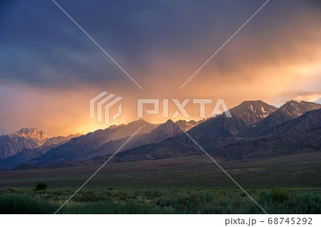 Mountain range with clouded colorful sunset, Eastern Sierra Nevada Mountains Mountain range with clouded colorful sunset, Eastern Sierra Nevada Mountains 68745292