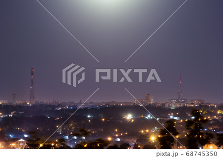 Night time city lights. Big city lighted with moon Night time city lights. Big city lighted with moon 68745350