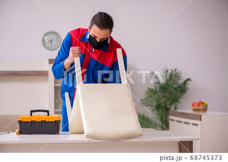 Young carpenter working indoors during pandemic disease Young carpenter working indoors during pandemic disease 68745373