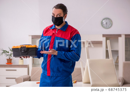 Young carpenter working indoors during pandemic disease Young carpenter working indoors during pandemic disease 68745375