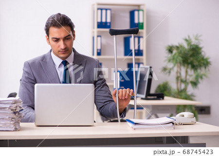 Leg injured employee in the office Leg injured employee in the office 68745423