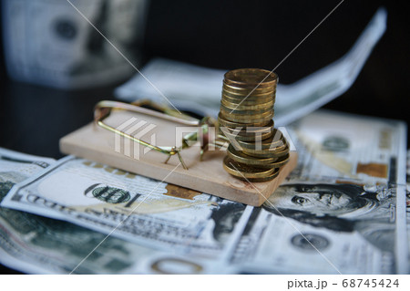 A stack of Euro coins on a mousetrap A stack of Euro coins on a mousetrap 68745424