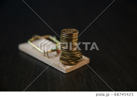 A stack of Euro coins on a mousetrap A stack of Euro coins on a mousetrap 68745425