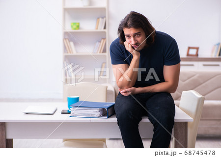 Young man employee working from house 68745478