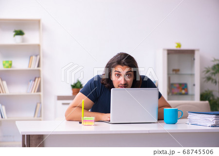 Young man employee working from house Young man employee working from house 68745506