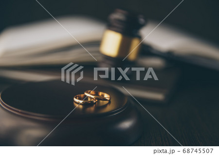 Close-up Of Wedding Rings And Wooden Gavel Close-up Of Wedding Rings And Wooden Gavel 68745507