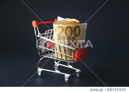 shopping cart filled with european currency notes, isolated on white shopping cart filled with european currency notes, isolated on white 68745920