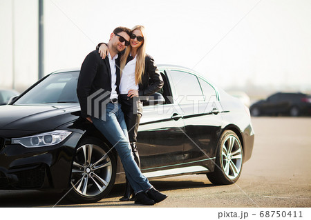 Happy young couple chooses and buying a new car for the family 68750411
