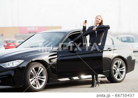 Young happy woman bought new modern car. Young happy woman bought new modern car. 68750437