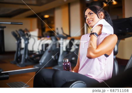 Young attractive woman doing exercises in fitness gym. Young attractive woman doing exercises in fitness gym. 68751108