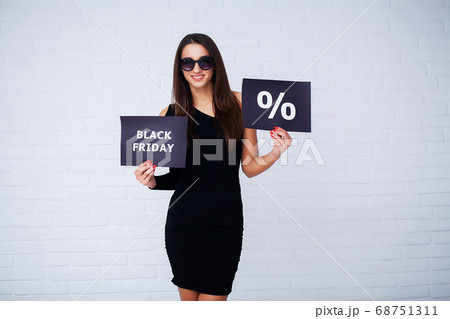 Black Friday. Woman with the inscription Black Friday and gift bags on a white background 68751311