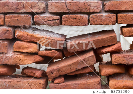 hole in an old brick wall collapsing 68755390