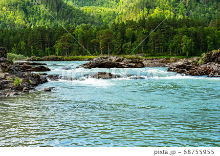 Stormy mountain river flowing along a mountain valley Stormy mountain river flowing along a mountain valley 68755955