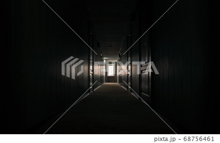 gloomy dark corridor with closed doors of an empty hotel without people during quarantine 68756461