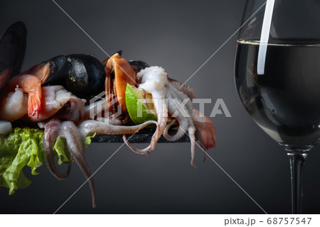 Mixed raw delicious seafood with lime slices and 68757547