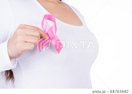 Breast cancer awareness ribbon on woman chest Breast cancer awareness ribbon on woman chest 68763682