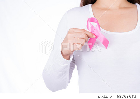 Breast cancer awareness ribbon on woman chest Breast cancer awareness ribbon on woman chest 68763683