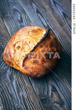 Homemade tartine bread on dark wooden table 68764069