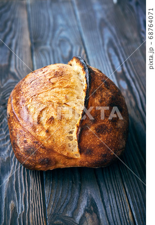 Homemade tartine bread on dark wooden table 68764071