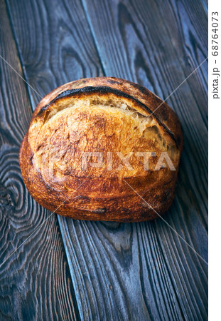 Homemade tartine bread on dark wooden table 68764073