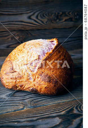 Homemade tartine bread on dark wooden table 68764087