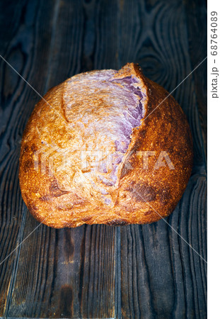 Homemade tartine bread on dark wooden table 68764089
