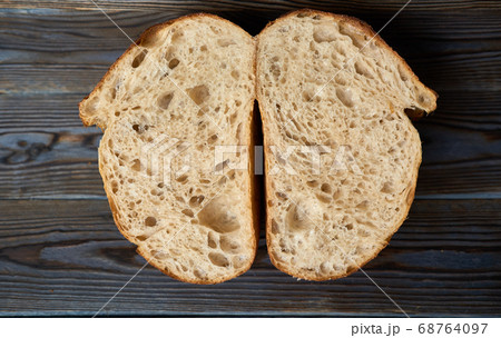 Homemade tartine bread on dark wooden table 68764097