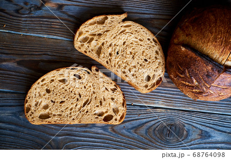 Homemade tartine bread on dark wooden table 68764098