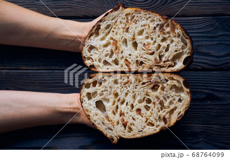 Homemade tartine bread in woman's hands 68764099