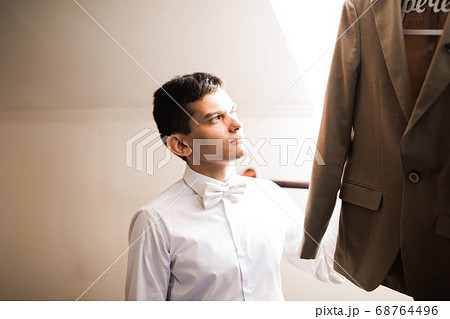 Beautiful man, groom posing and preparing for wedding 68764496