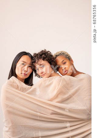 Asian, Caucasian and African girls wrapped into linen standing in isolation 68765356