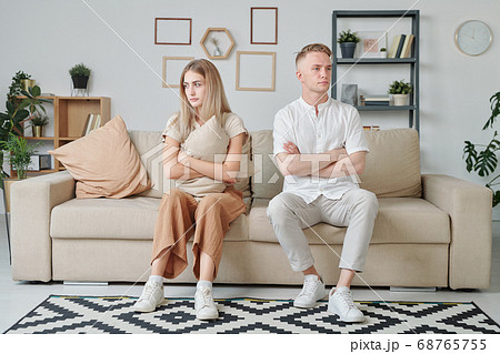 Young married couple with crossed arms and offended facial expression 68765755