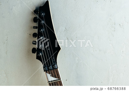 Guitar headstock with tuners on dark background Guitar headstock with tuners on dark background 68766388