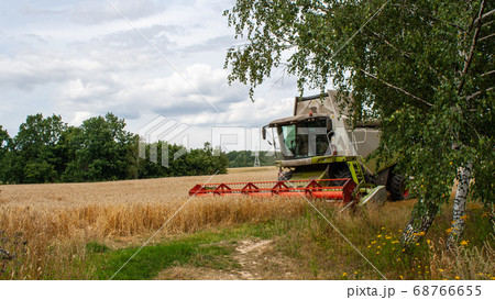 Modern harvester at work in field during wheat 68766655