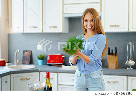 Close up portrait of a woman holding fresh greens 68766890