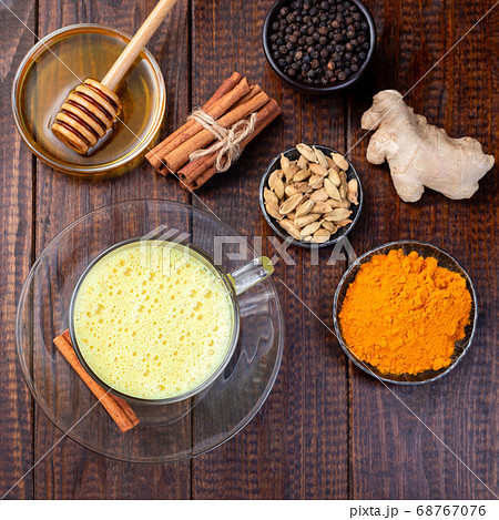 Turmeric moon milk in glass cup, ingredients Turmeric moon milk in glass cup, ingredients 68767076