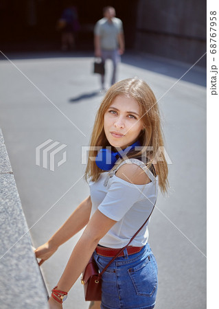 Pretty young white lady walks outdoors. Pretty young white lady walks outdoors. 68767958